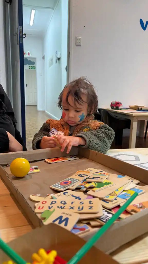 A child with alphabet puzzles